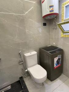 a bathroom with a toilet and a trash can at Leila Home Garden - Maamourah Beach in Alexandria +11 photos
