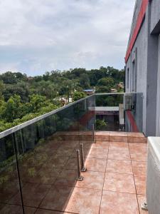 a balcony with a view of a building at SOMBRAS DEL PARANA Apart Misiones in Eldorado