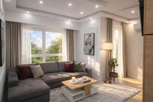 a living room with a couch and a table at Extra Apartman in Banja Luka