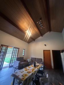 a dining room with a table and a couch at Recanto do curio in Aparecida