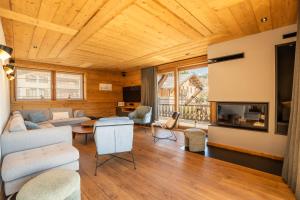 a living room with a couch and a fireplace at Chalet Téléporté Jacuzzi Hammam Cheminée 14 pers - MultiPass in Les Gets