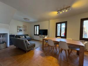 a living room with a wooden table and chairs at Casa Miradell in Hoz de Jaca