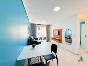 a living room with a white table and chairs at Brisa do Mar Residence by Holiday Stays in Fortaleza