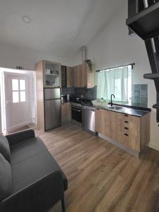 a kitchen with stainless steel appliances and wooden floors at Casinhas da Ajuda nº15 in Lisbon