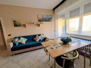 a living room with a couch and a table at In Via Capri 1991 APARTMENT in Follonica