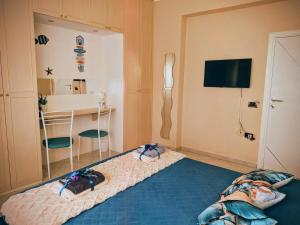a bedroom with a bed with two slippers on it at In Via Capri 1991 APARTMENT in Follonica