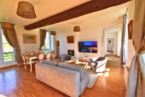 a living room with a couch and a table at Château de Ravenel in Ravenel