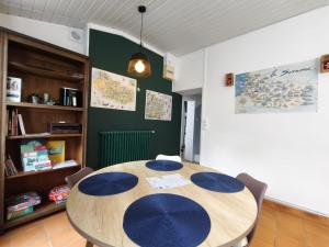 a dining room with a wooden table and chairs at La petite Tourelle Ruelle de la Fontaine in Péronne
