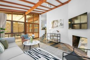 a living room with a couch and a fireplace at North Perth 3BR Home Steps To Hyde Park & Dining in Perth