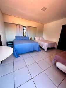 a bedroom with two beds and a tiled floor at CasaMar21- 12 km de Maceió e 10 km FRAN6 in Maceió +82 photos