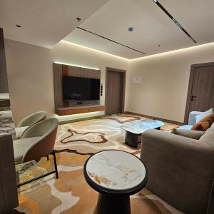 a living room with a couch and a tv at Wahed Numas in Hail