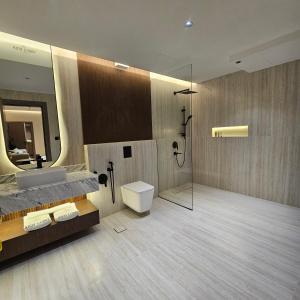 a bathroom with a sink and a toilet and a shower at Wahed Numas in Hail