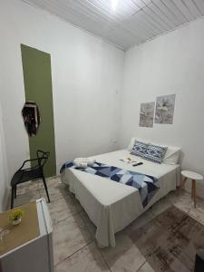 a bedroom with a bed and a chair in it at Pousada Laviê Morada de Leste in Pontal do Paraná