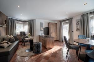 a living room with a couch and a table at VILLA A elevated alpine living in Selva di Val Gardena