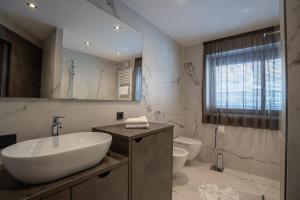 a bathroom with a sink and a toilet at VILLA A elevated alpine living in Selva di Val Gardena +47 photos