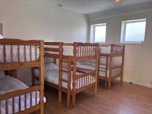 a room with three bunk beds and a table at Dover Priory Hotel in Dover +9 photos