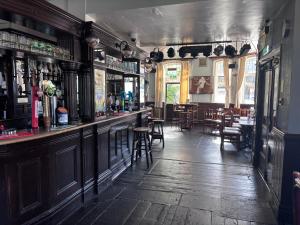 a bar in a pub with tables and chairs at Dover Priory Hotel in Dover
