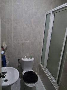 a bathroom with a shower and a toilet and a sink at Borges Place in Praia