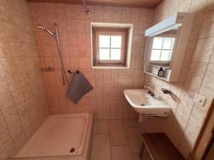 a bathroom with a shower and a sink and a tub at  