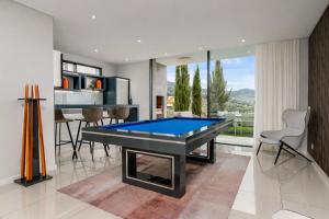 a living room with a pool table in it at Luxury Ocean View Villa I Swimming pool I Vincents Place in Estreito da Calheta