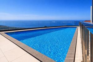 a swimming pool on the roof of a building at Luxury Ocean View Villa I Swimming pool I Vincents Place in Estreito da Calheta