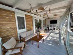 a porch with a couch and a table on a house at Dream Escape Mobile Home in Vodice