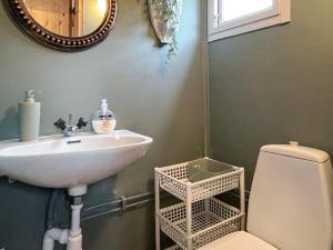 a bathroom with a sink and a toilet and a mirror at 4 person holiday home in SÖDERKÖPING in Söderköping +60 photos