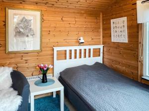 a bedroom with a bed in a wooden cabin at 4 person holiday home in SÖDERKÖPING in Söderköping