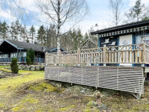 a house with a large wooden deck in front of it at 4 person holiday home in SÖDERKÖPING in Söderköping