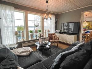 a living room with a couch and a tv at 4 person holiday home in SÖDERKÖPING in Söderköping