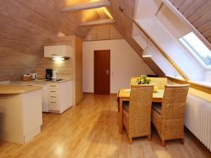 a kitchen and dining room with a table and chairs at Ferienwohnung in Westerland auf Sylt in Westerland