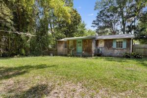 a small brick house with a yard at The Downtown Cedar in Ocean Springs