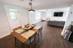 a living room with a table and a couch at The Downtown Cedar in Ocean Springs