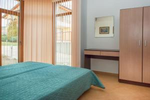 a bedroom with a bed and a dresser and a mirror at Montemar Villas in Sunny Beach +29 photos