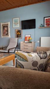 a living room with a couch and a flat screen tv at ANASA in Stavros
