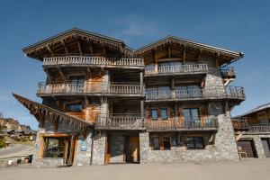 a large wooden building with balconies on it at Chalet Téléporté Jacuzzi Hammam Cheminée 14 pers - MultiPass in Les Gets