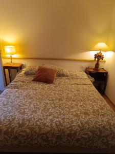 a bedroom with a large bed with a pillow on it at domaine des trois rivières in Sainte-Marguerite-de-Viette