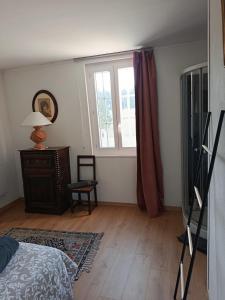 a bedroom with a bed and a window at domaine des trois rivières in Sainte-Marguerite-de-Viette