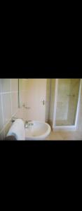 a bathroom with a sink and a shower at Cozy guestrooms in Midrand in Midrand