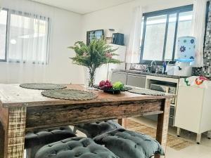 a kitchen with a wooden table in a room at Casa das Cachoeiras in Botucatu +16 photos