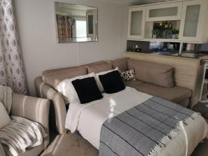 a living room with a couch and a bed at Washbrook Way 2 in Fenny Bentley