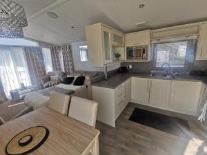 a kitchen and living room with a couch and a table at Washbrook Way 2 in Fenny Bentley