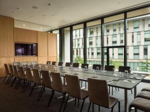 a large conference room with a long table and chairs at The Study at University City in Philadelphia