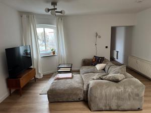 a living room with a couch and a flat screen tv at Zum alten Pasewalker Kaufmann in Pasewalk