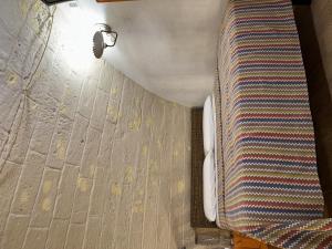a bathroom with a wall with a toilet and a light at More Apartments il castello in Bari