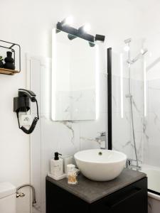 a bathroom with a sink and a mirror at Le doux refuge domaine thermal et activités touristiques Amnéville in Amnéville +7 photos