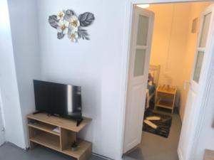 a room with a flat screen tv and a tv stand at Villa fisfiri 1 in Serifos Chora