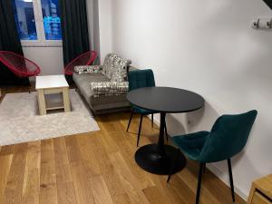 a living room with a table and chairs and a couch at Bjelašnica by Samke in Bjelašnica