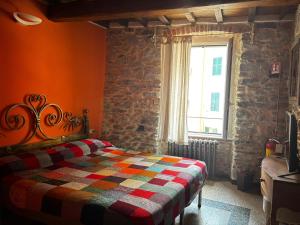 a bedroom with a bed with a colorful quilt at Cà Della Valletta in Riomaggiore
