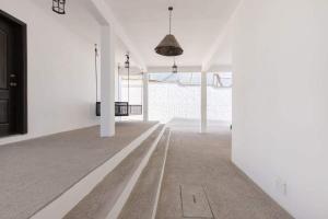 an empty room with white walls and white columns at Luxury & Spacious Beachfront Home Casa Espiritu in Puerto Peñasco